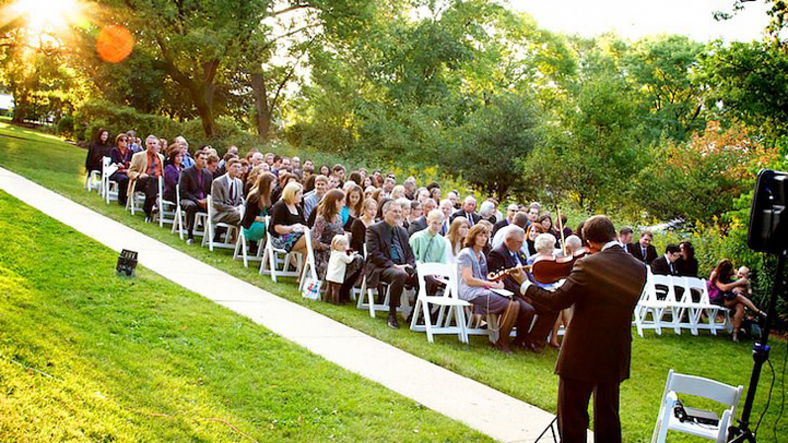 an outdoor wedding ceremony at the highland park community house